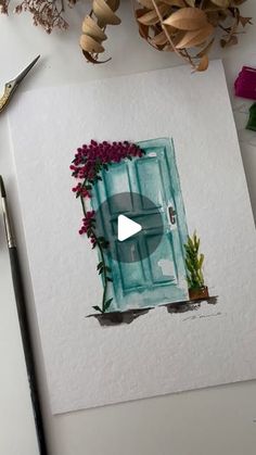 a drawing of a door with flowers and scissors next to it on top of a table