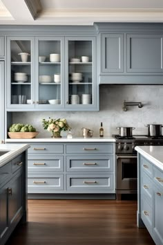 a kitchen with blue cabinets and white counter tops