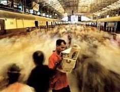 a crowd of people walking through a train station