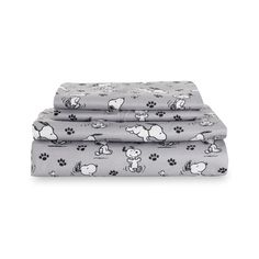 two sheets with dogs and paw prints on them, one is grey and the other is white