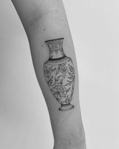 a black and white photo of a vase on the arm