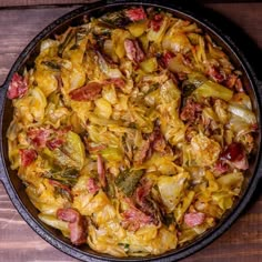 a pan filled with food sitting on top of a wooden table