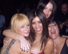 four women posing for the camera at a party