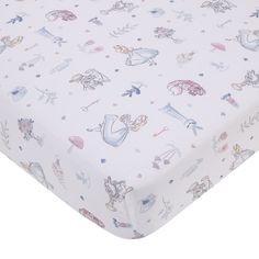 a white sheet with cartoon characters on it and pink trimmings, sitting on top of a bed