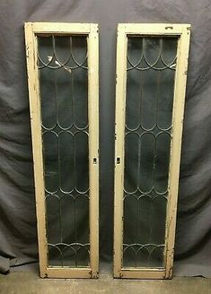 pair of antique leaded glass doors with white trims on the sides and bottom