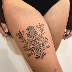 a woman with a tattoo on her thigh