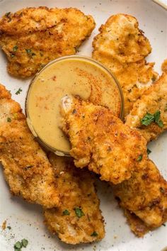 fried chicken with dipping sauce on a white plate