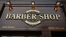 the sign for barber shop is lit up