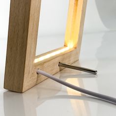 a light that is on top of a table next to a pen and some wires