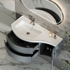 a white sink sitting under a mirror next to a wall mounted faucet in a bathroom