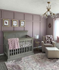 a baby's room with purple walls and furniture in the corner, along with a chandelier