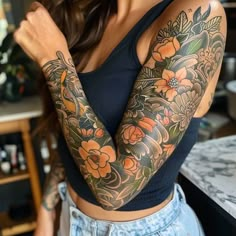 a woman with tattoos on her arms and shoulder