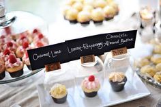 cupcakes and other pastries are displayed on a table