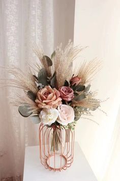 a vase filled with flowers sitting on top of a white table next to a window