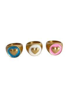 three rings with hearts on them sitting next to each other