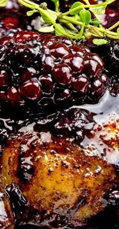 some blackberries are sitting on top of meat