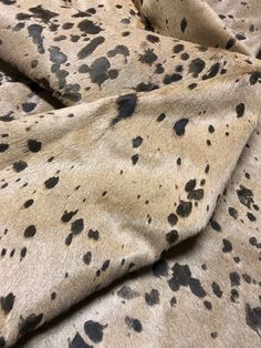 black and white spotted fabric with spots on it's surface, as if in an animal print