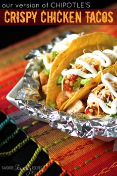 some tacos are sitting in foil on top of a colorful table cloth with the words our version of chipotle's crisp chicken tacos