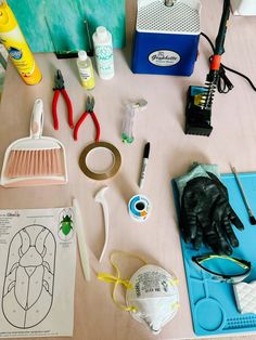 various crafting supplies laid out on a table with scissors, glue and other items