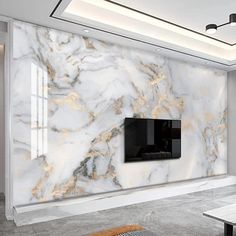 a living room with white and gold marble wallpaper on the walls next to a flat screen tv