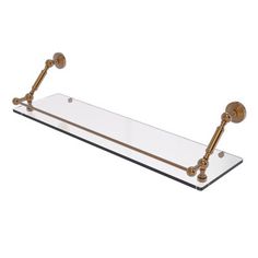 a glass shelf with two brass handles