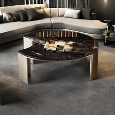 a living room filled with furniture and a book on top of a glass coffee table