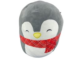 a stuffed penguin with a red scarf around its neck