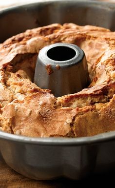 a bundt cake in a metal pan on a wooden table