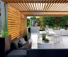 an outdoor living area with wooden slatted walls