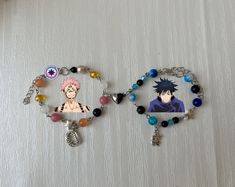 two bracelets with anime characters on them