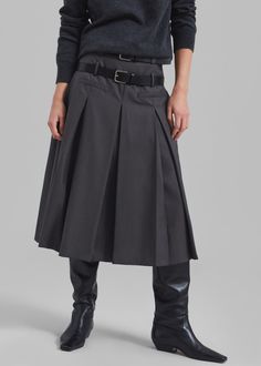 Color: Grey Lightweight woven fabric Relaxed fit Midi length Tennis pleats throughout Front illusion welt pockets Double belt loops Concealed side seam zip closure Partially lined 60% Polyester 25% Rayon 15% Wool Dry Clean By The Frankie Shop. Imported Belted Skirt For Workwear In Fall, Belted Skirt For Fall Workwear, Fitted Pleated Flared Skirt With Belt Loops, Fitted Pleated Skirt With Belt Loops For Fall, Fall Workwear Belted Skirt, Modern Skirt With Belt Loops For Work, Workwear Flared Skirt With Belt Loops, Fall Workwear Belted Pleated Skirt, Classic Belted Skirt For Workwear