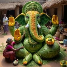 a woman kneeling down next to an inflatable statue of an elephant with corn on its trunk