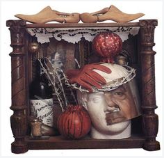 a painting of a man's head in a frame with other items around it