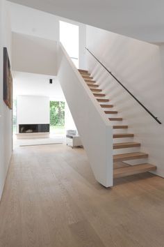 an empty room with stairs leading up to the second floor