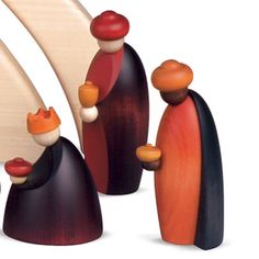 three wooden figurines standing next to each other