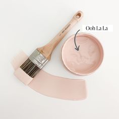 a paintbrush and bowl with the words ooh la la painted on it next to an object