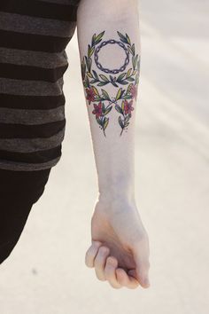 a person with a flower tattoo on their arm