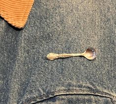 a spoon sticking out of the back pocket of a pair of jeans