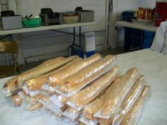 a pile of baguettes sitting on top of a table