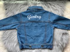 "Hello and welcome to my shop!! Here we have our super cute denim jackets. I can add a name to the front left or to the back of the jacket. These are perfect for that cute birthday picture. I can also add your favorite school or logo to them. Make sure to let me know what thread color at checkout. If not specified I'll do it in white If you would like to add flowers, stars, hearts or other designs to the jacket purchase extra monograms here: https://www.etsy.com/listing/796309653/add-to-my-order Customizable Blue Denim Jacket, Customizable Blue Denim Jacket With Long Sleeves, Fitted Cotton Outerwear With Letter Print, Customizable Blue Denim Jacket For Spring, Customizable Denim Jacket For Spring, Customizable Denim Jacket For Fall, Customizable Spring Denim Jacket, Customizable Trendy Denim Jacket For Spring, Spring Customizable Denim Jacket