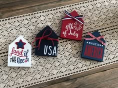 three patriotic tags on a doily with red, white and blue decorations in the shape of houses