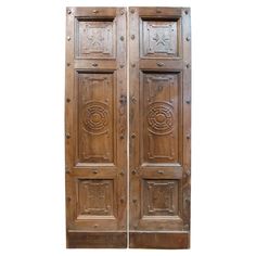 two wooden doors with decorative carvings on them