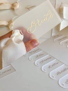 a person holding up a white card with the word bride on it and some other cards in front of them