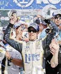 nascar fans celebrate with their trophies and confetti