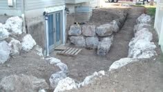 a pile of rocks sitting in front of a house