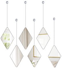 four mirrors hanging from the ceiling in different shapes