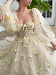 Details:-Soft beige tulle with embroidered daisies and daffodils-Sweetheart neckline with a decorative bow and a small opening in the front-Decorative divider in the bodice-Wide, puffy long sleeves with zippers in the tight cuffs-Tea length-... Beige Square, Embroidery Tulle, Sleeves Embroidery, Fairytale Dress, Tulle Wedding Dress