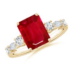 a gold ring with a large red stone surrounded by white diamonds on the sides and an oval cut diamond in the middle