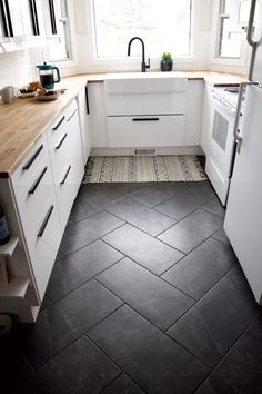 a kitchen with black and white tile flooring