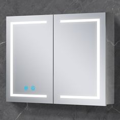 a bathroom mirror that is on the wall with light coming from it's sides